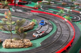 Electric slot cars on the toy race track ready to play